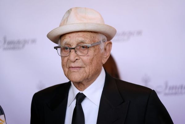 A portrait of an elderly man in a hat and glasses.