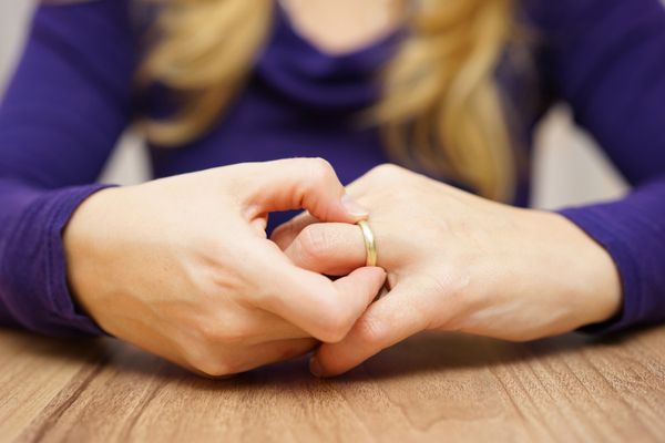 A woman touching her ring finger | Source: Shutterstock