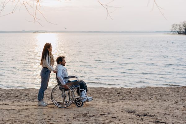A woman with a man on a wheelchair | Source: Pexels