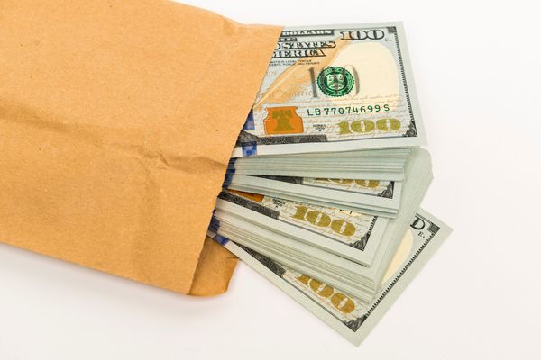 Several dollar bills in an envelope