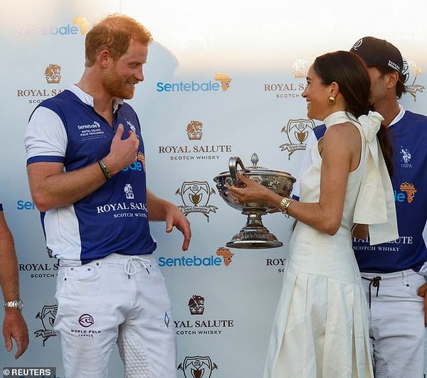 The Duchess of Sussex, 42, beamed with delight as she presented her husband with his trophy