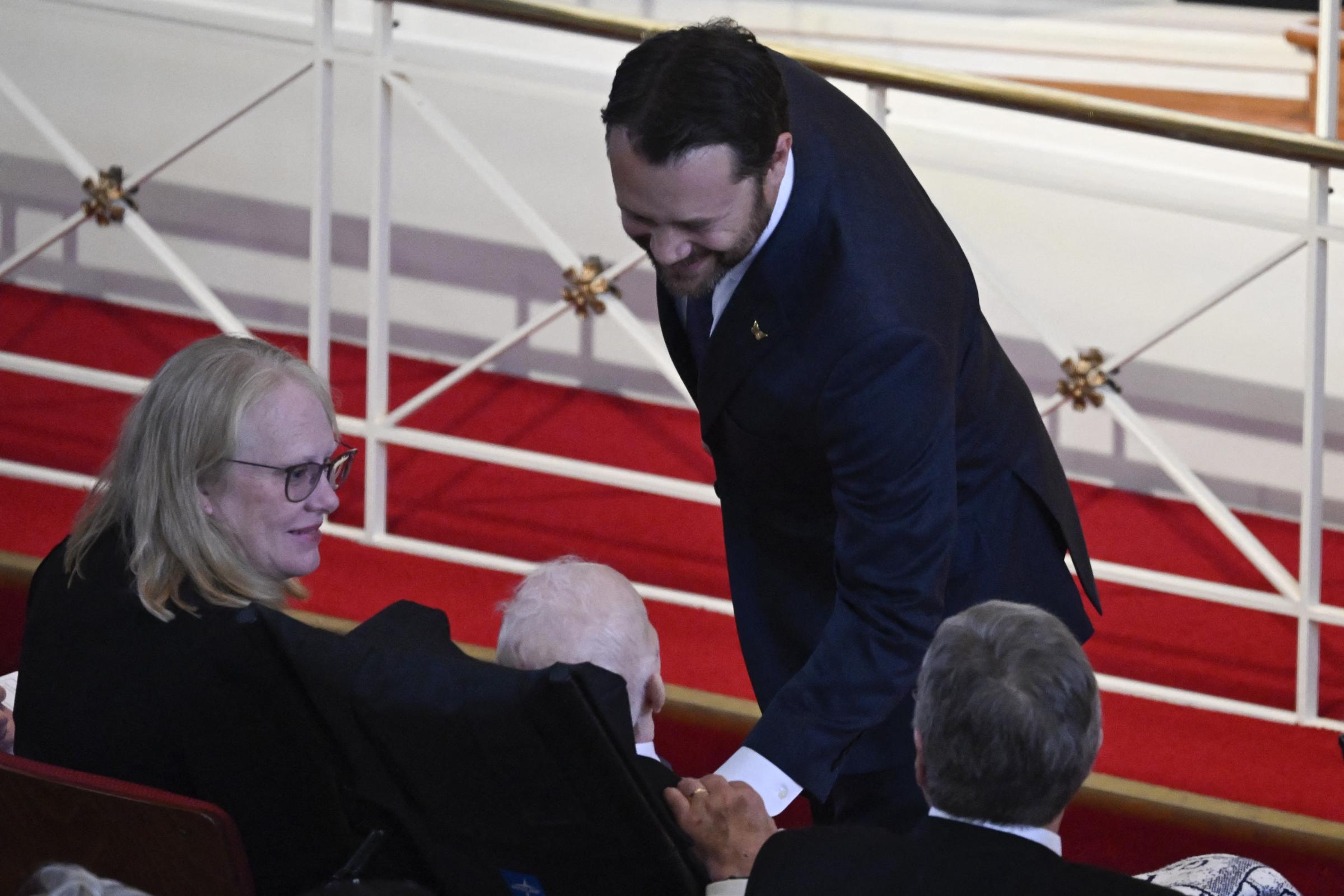 Jason Carter smiles to his grandfather, Jimmy Carter. | Source: Getty Images